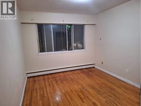 Vancouver apartment for rent - A room with wooden flooring and a window.