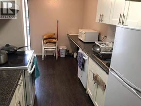 Richmond apartment for rent - A kitchen with white appliances and wooden floors.