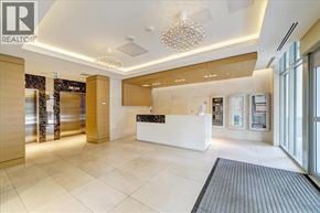 Richmond apartment for rent - A reception area with a white counter and a chandelier hanging from the ceiling.