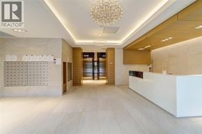 Richmond apartment for rent - A reception area with a white reception desk and a chandelier hanging from the ceiling.