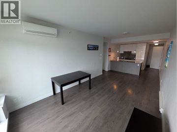 Richmond apartment for rent - A living room with a black table and a television.