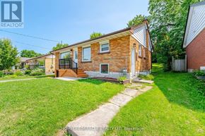 Waterloo apartment for rent - A brick house with a lawn in front.