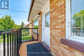 Waterloo apartment for rent - A brick house with a white door and a black railing.