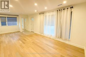 Toronto (Wexford-Maryvale) apartment for rent - A spacious room with wooden flooring and white walls.