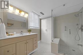 Richmond Hill (North Richvale) condo for rent - A bathroom with a sink, mirror, and shower.