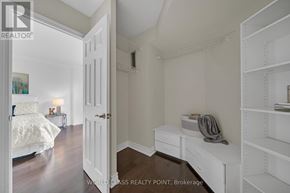 Richmond Hill (North Richvale) condo for rent - A bedroom with a bed, nightstand, and a shelf.