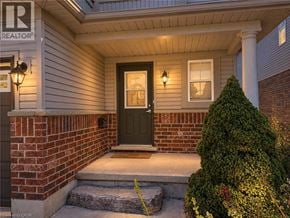 Waterloo apartment for rent - A house with a black door and a small tree in front.