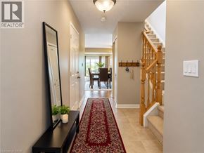 Waterloo apartment for rent - A hallway with a rug and a staircase.