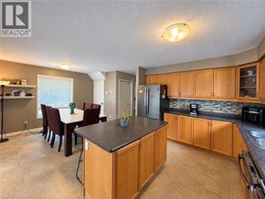 Waterloo apartment for rent - A kitchen with wooden cabinets and a black countertop.