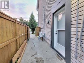 Toronto (Junction Area) multi-family for rent - A wooden fence and a grey door are visible in the image.