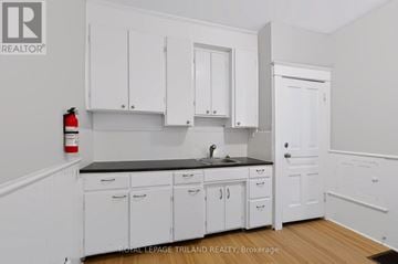 London East (East L) apartment for rent - A kitchen with white cabinets and a black countertop.