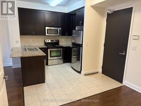 Vaughan (West Woodbridge) condo for rent - A kitchen with a granite countertop and stainless steel appliances.