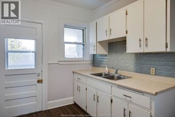 Windsor apartment for rent - A kitchen with white cabinets and a sink.