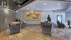 Toronto (Bay Street Corridor) condo for rent - A living room with a grey couch, a coffee table, and a painting on the wall.