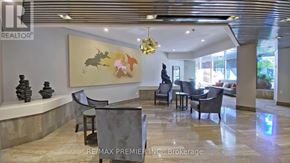 Toronto (Bay Street Corridor) condo for rent - A living room with a grey sofa, a coffee table, and a large painting on the wall.