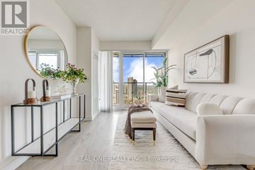 Toronto (Church-Yonge Corridor) condo for rent - A modern living room with a white sofa and a large window.