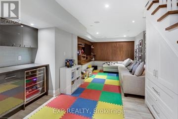 Toronto (South Riverdale) apartment for rent - A living room with a white couch and a colorful rug.