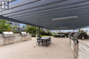 Toronto (Islington-City Centre West) condo for rent - A patio with a table and chairs under a roof.