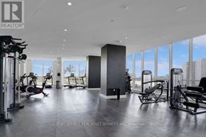 Toronto (Islington-City Centre West) condo for rent - A gym with a view of the city outside the windows.