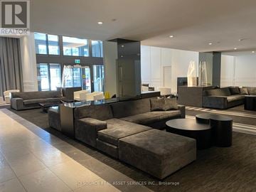 Toronto (Islington-City Centre West) condo for rent - A large, modern living room with a grey sofa set and a black coffee table.