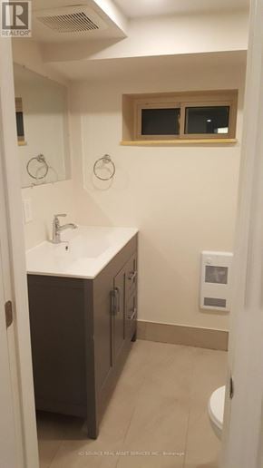 Toronto (Mount Dennis) townhouse for rent - A bathroom with a sink, mirror, and toilet.
