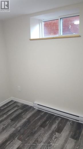 Toronto (Mount Dennis) townhouse for rent - A room with a window and wooden flooring.
