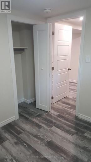Toronto (Mount Dennis) townhouse for rent - A hallway with a white door and a grey floor.