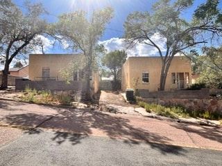 Gallup apartment for rent - A sunny day in front of a building with trees.