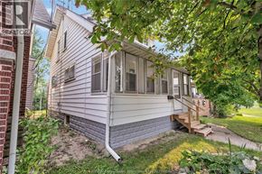 Windsor apartment for rent - A house with a grey siding and a brown deck.
