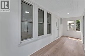 Windsor apartment for rent - A hallway with white walls and wood flooring.