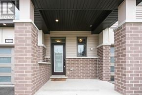Ottawa townhouse for rent - The entrance to a building with a glass door and a brick wall.