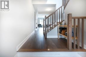 Ottawa townhouse for rent - A long hallway with a staircase on the right side.