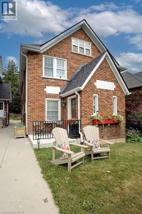 Waterloo apartment for rent - A house with a red brick exterior and a white sign on the front.