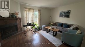 Brantford townhouse for rent - A living room with a fireplace and a grey couch.