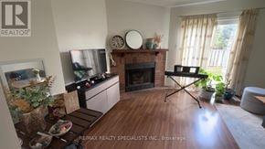 Brantford townhouse for rent - A living room with a fireplace and a TV on the wall.