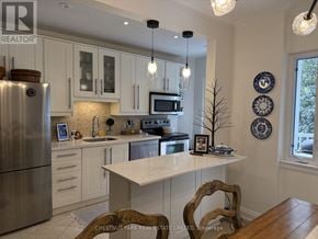 Toronto (Lawrence Park South) fourplex for rent - A kitchen with a refrigerator, microwave, and oven.