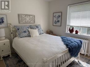 Toronto (Lawrence Park South) fourplex for rent - A white bed with a blue throw blanket and matching pillow cases.
