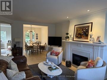 Toronto (Lawrence Park South) fourplex for rent - A living room with a fireplace and a painting on the wall.