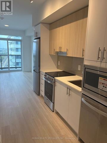 Mississauga (Hurontario) condo for rent - A kitchen with white cabinets and stainless steel appliances.