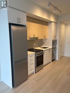 Mississauga (Hurontario) condo for rent - A kitchen with a refrigerator, oven, and microwave.