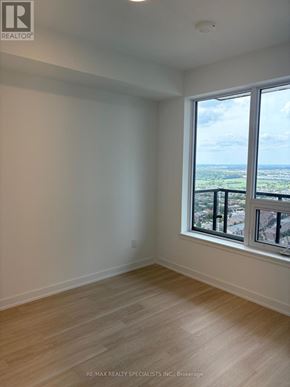 Mississauga (Hurontario) condo for rent - A room with a large window overlooking a landscape.