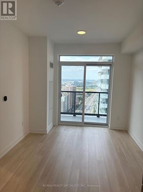 Mississauga (Hurontario) condo for rent - A room with a view of the city through a large window.