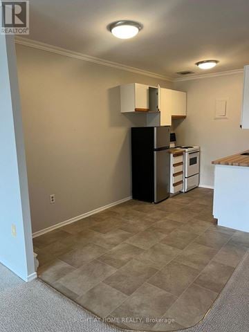 London South (South X) condo for rent - A kitchen area with a black refrigerator and a microwave.