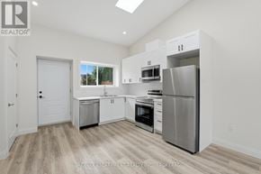 St. Catharines (E. Chester) apartment for rent - A kitchen with white cabinets and stainless steel appliances.