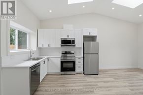 St. Catharines (E. Chester) apartment for rent - A modern kitchen with white cabinets and stainless steel appliances.