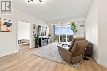 Burlington (Brant) condo for rent - A living room with a brown chair and a grey rug.