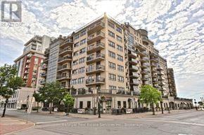 Burlington (Brant) condo for rent - A large apartment building with a sign for Trafalgar Real Estate Services Inc. Brokerage in front of it.