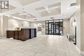 Burlington (Brant) condo for rent - A reception area with a wooden desk and a bench.