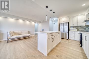 Toronto (Don Valley Village) condo for rent - A well-lit kitchen and living room with a sofa and a dining area.
