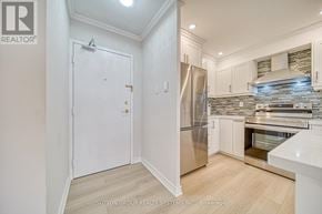Toronto (Don Valley Village) condo for rent - A kitchen with white cabinets and a stainless steel refrigerator.